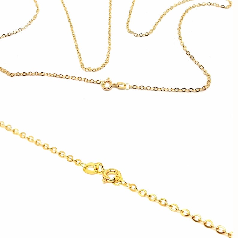 May include: Close-up of several delicate gold-colored chain necklaces. The chains have a fine, linked design and are shown against a white background. Each necklace features a clasp for secure fastening. The chains are likely for jewelry making or wearing.