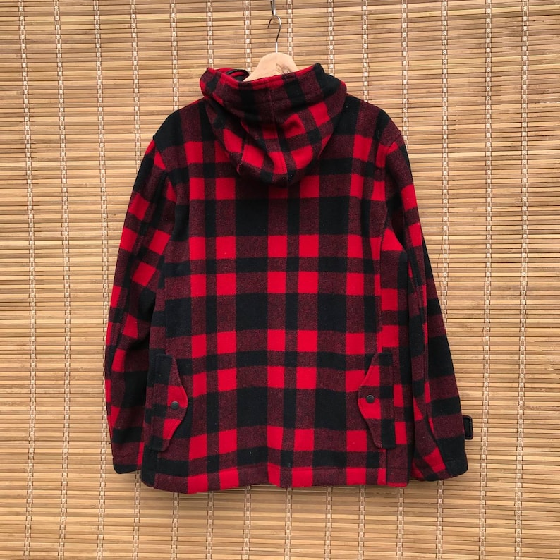 May include: Red and black plaid hooded jacket with a zipper closure and two pockets.