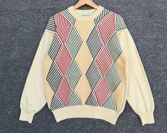 Suéter vintage Burberry de lana con rombos geométricos de Londres de los años 90, color crema/multicolor, cuello acanalado y logotipo del caballero bordado.