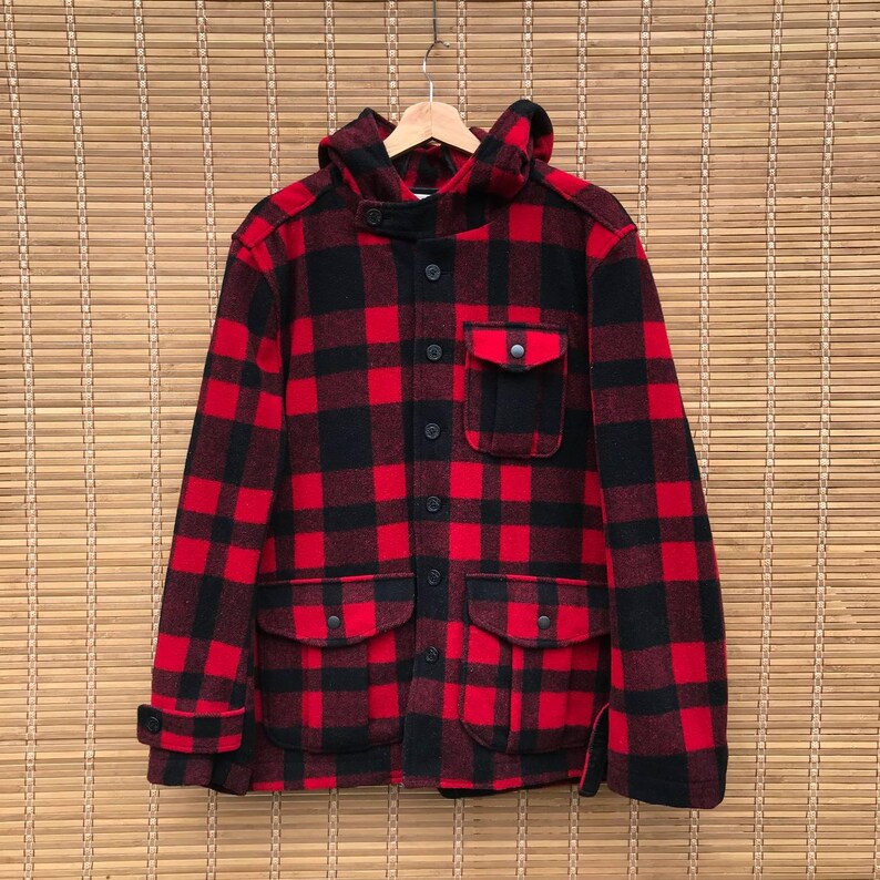 May include: Red and black plaid hooded jacket with a button closure and two large pockets.