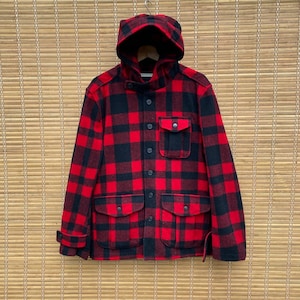 May include: A red and black plaid hooded jacket with a button front and two large pockets. The jacket is made of a thick, warm material.