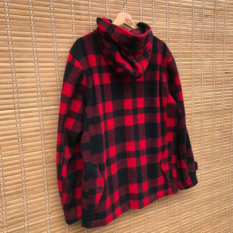 May include: Red and black plaid hooded jacket with a zipper closure and two pockets.