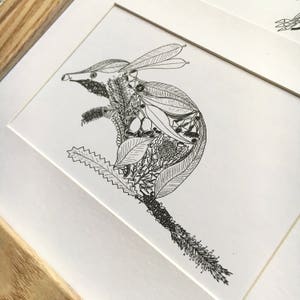 May include: A black and white line drawing of a bandicoot made entirely of leaves, flowers, and other botanical elements.