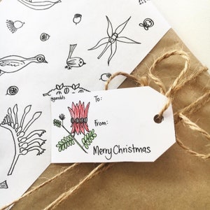 May include: A white gift tag with a red and green floral illustration and the text "To:", "From:", and "Merry Christmas".