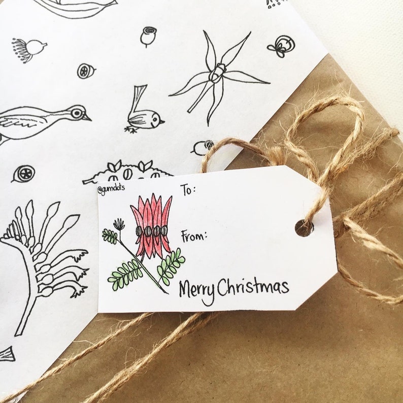 May include: A white gift tag with a red and green floral illustration and the text "To:", "From:", and "Merry Christmas".
