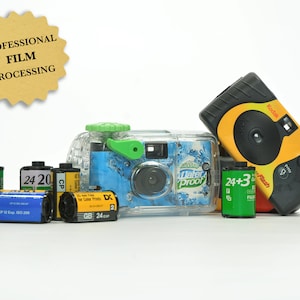 May include: A collection of disposable cameras and film rolls, including a yellow Kodak FunSaver camera, a blue and green waterproof camera, and rolls of 24 exposure film. The text "PROFESSIONAL FILM PROCESSING" is on a brown starburst sticker.