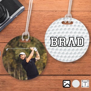 May include: White golf ball luggage tag with the name "BRAD" printed in black. The tag is attached to a white string. A second image shows a golfer swinging a golf club on a green golf course.