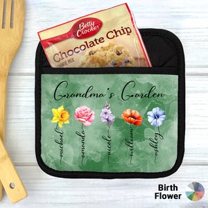 May include: A green pot holder with a black border and a pocket. The pot holder has a watercolor design of flowers and the text "Grandma's Garden". Below the flowers are the names "Michael, Amanda, Nicole, William, Ashley".