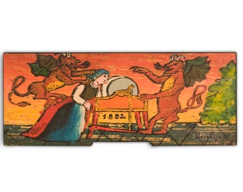 May include: A vintage illustration of a woman sitting at a spinning wheel with two red devils on either side of her. The woman is wearing a blue dress and a white head covering. The devils have horns, wings, and tails. The spinning wheel is red and has the number 1882 on it. The background is a sunset.