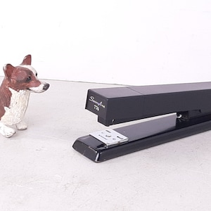 May include: Black Swingline 776 stapler with a silver staple remover. The stapler is on a white surface.