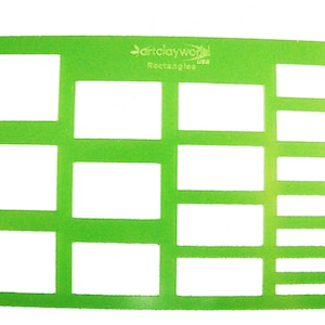 May include: Green plastic template with multiple rectangular cutouts of different sizes. The template is labeled "Art Clay World USA Rectangles".