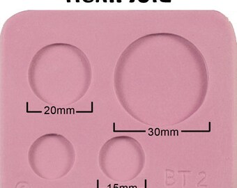 May include: Pink silicone mold with four circular cavities. The mold has measurements marked in millimeters: 20mm, 30mm, and 15mm. The text "BT2" is printed on the mold.