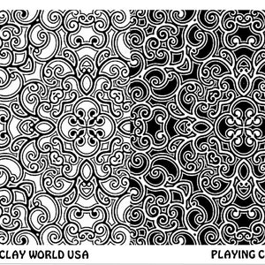 May include: Black and white playing card with a decorative, intricate pattern. The card has the text "ART CLAY WORLD USA" on the left side and "PLAYING CARD" on the right side.