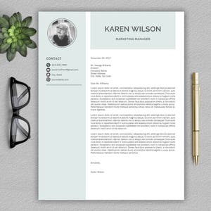 May include: A professional CV template with a light green background and a photo of a woman in the top left corner. The text "KAREN WILSON" is in a larger font size and the text "MARKETING MANAGER" is in a smaller font size. The CV includes contact information, a date, and a covering letter.