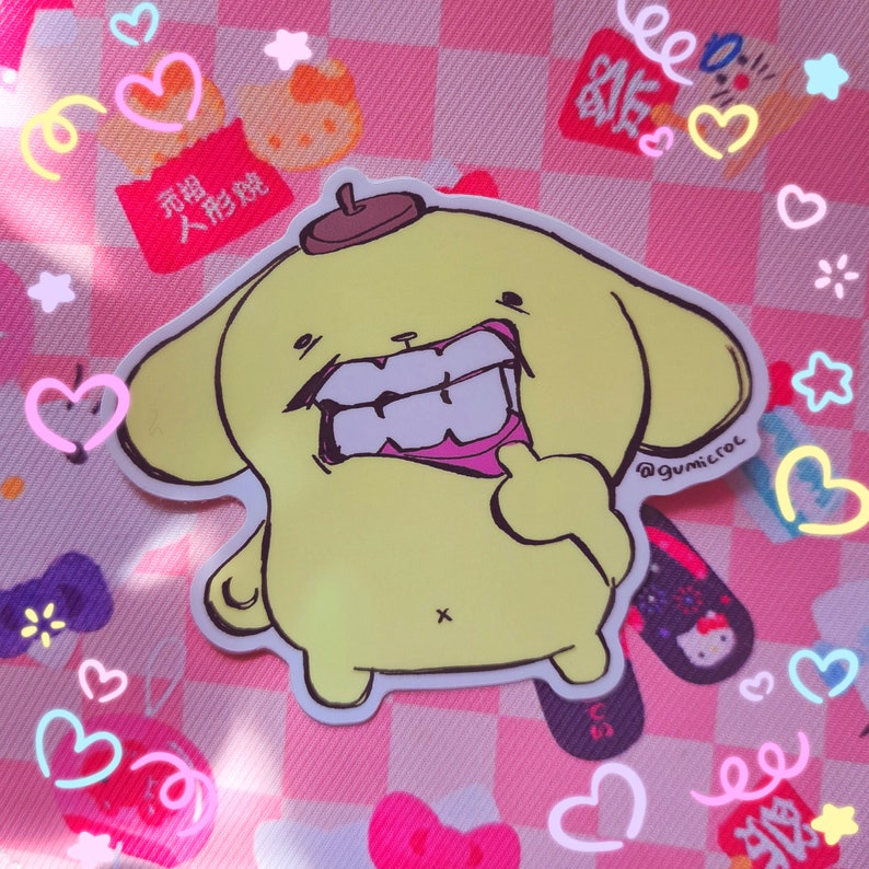 May include: A yellow cartoon sticker of a character with a brown hat and large teeth, giving a thumbs up. The sticker is on a pink checkered background with hearts and other decorative elements.