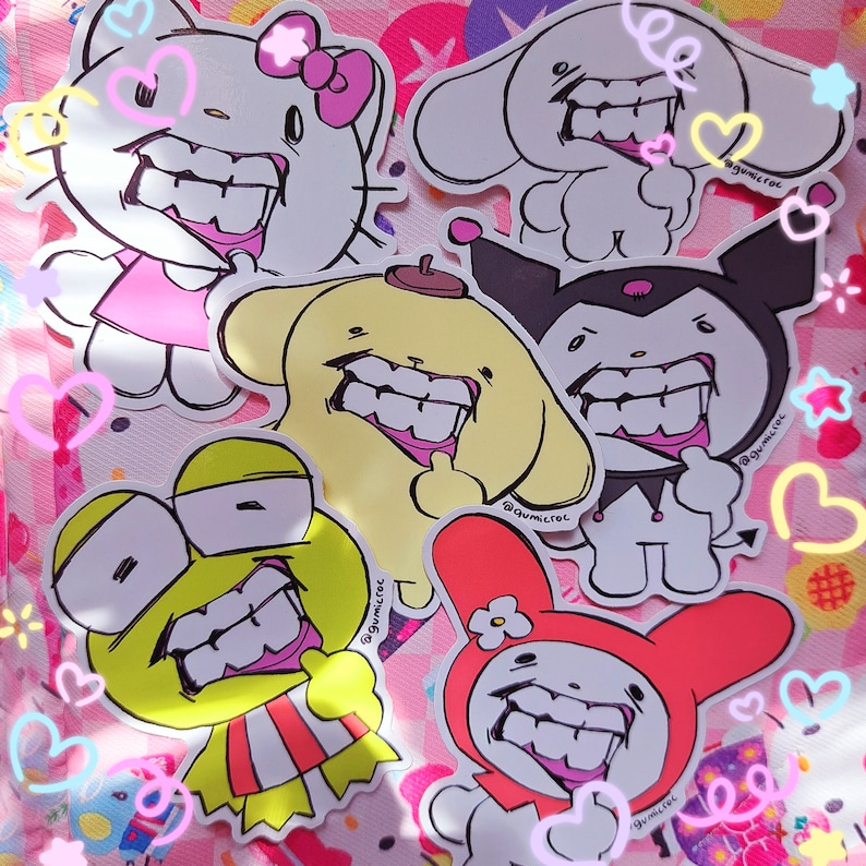 May include: A collection of cartoon character stickers, including Hello Kitty, Cinnamoroll, and My Melody, each with a unique, exaggerated grin. The stickers are outlined in black and feature bright colors like pink, yellow, and red. The background is a pink and white pattern with heart and star accents.