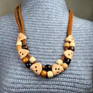 Ethnic necklace made of porcelain and natural leather, decorated with porcelain and wood beads. Handmade boho chic jewelry.
