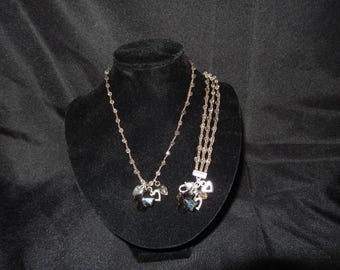 Ensemble collier et bracelet BRIGHTON KARMA CROSS - Croix en cristal fumé avec breloques coeur en argent - Cordon perlé tressé marron - Parure de bijoux obsolètes