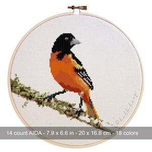 May include: Cross-stitch embroidery of an orange and black bird perched on a branch, set in a wooden hoop. The embroidery is 7.9 x 6.6 inches (20 x 16.8 cm) and uses 18 colors. The text reads "14 count AIDA - 7.9 x 6.6 in - 20 x 16.8 cm - 18 colors".