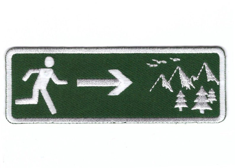 May include: Green rectangular embroidered patch with a white running figure pointing right with an arrow. The background features white mountains and trees.