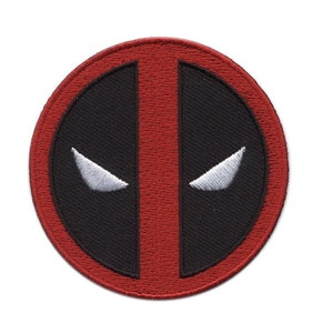 May include: A circular embroidered patch displaying the Deadpool logo. The design features a black background with white eye shapes and a vertical red stripe, enclosed by a red border. Suitable for application on clothing or accessories.