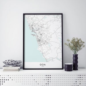 May include: A black framed print of a map of Goa, India. The map shows the roads and coastline of the state. The print is on a white background with the word "GOA" and "INDIA" printed in black at the bottom.