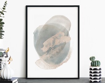May include: A framed abstract art print with a large, light blue and gray watercolor circle with a subtle gold glitter texture. The print is on a white background and is framed in a black frame.