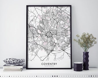 May include: Black and white map print of Coventry, United Kingdom in a black frame. The map is printed on white paper with black lines and pink shaded areas. The city name and country are printed in black at the bottom of the map.