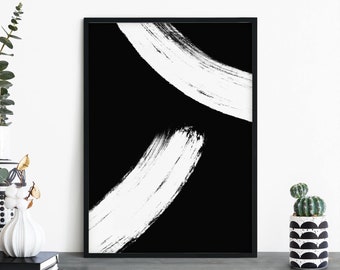 Op de afbeelding: Zwart-witte abstracte kunstprint met twee witte penseelstreken op een zwarte achtergrond. De print is ingelijst in een zwart frame.
