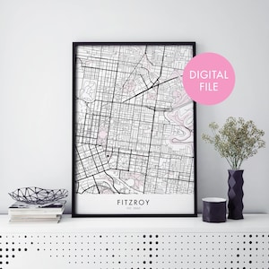 May include: A black and white map of Fitzroy, VIC 3065, Australia, in a black frame. The map is printed on white paper and has a pink outline of the city. The text "DIGITAL FILE" is written in a white circle on a pink background.