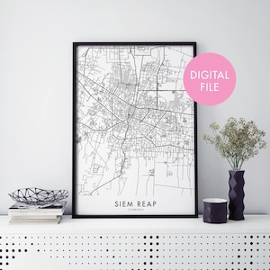 Pode incluir: Um mapa imprimível em preto e branco de Siem Reap, Camboja, em uma moldura preta. O mapa mostra as ruas e estradas da cidade. O texto "Siem Reap, Camboja" é impresso abaixo do mapa.