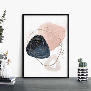 May include: Abstract art print with pink and blue watercolor shapes and gold accents. The print is framed in a black frame.