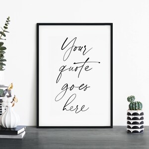 May include: Black and white printable wall art with the text "Your quote goes here" in a handwritten script font.
