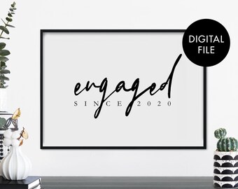 May include: Black and white printable art print with the text "engaged since 2020" in a modern calligraphy font.