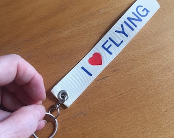 I Love Heart Flying Palm-sized Keyfob. Cream ribbon with blue lettering. airplane/aviation/pilot gift