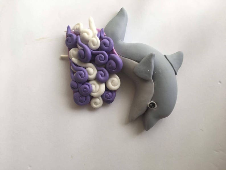 Dolphin cake topper made out of fondant