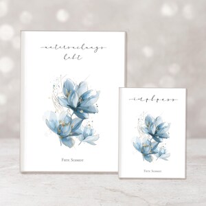 May include: Two white notebooks with watercolor floral designs. The larger notebook has the text "waterdraags hebt" and the smaller notebook has the text "inbless". Both notebooks feature blue flowers with gold accents.