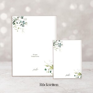 May include: Two white rectangular cards with watercolor floral corner designs. The larger card has the text "Du bist Unser Gl&uuml;ck" and a signature. The smaller card has a similar design. The word "R&uuml;ckseiten" is at the bottom.
