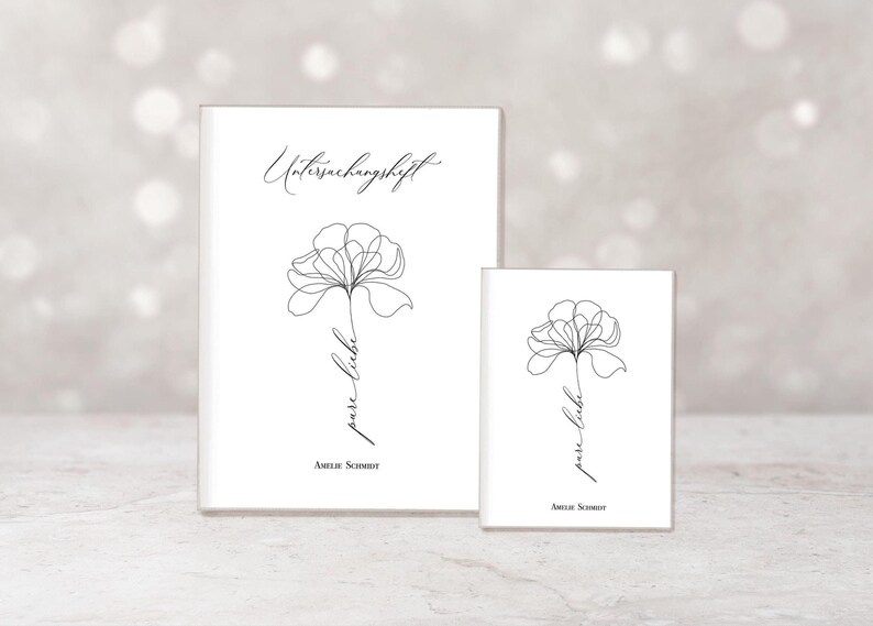 May include: Two white notebooks featuring a minimalist floral line drawing. The larger notebook has the text "Untersuchungshft" and the smaller one has "pure liebe". Both have the name "Amelie Schmidt" at the bottom.