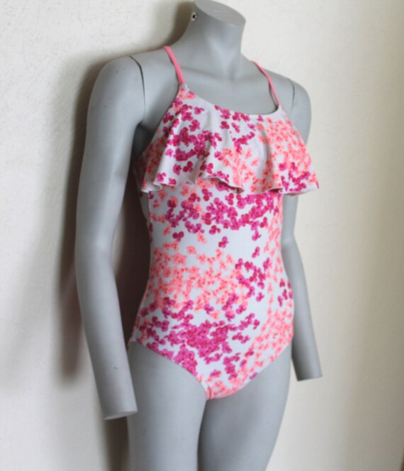white swimsuit with pink flowers