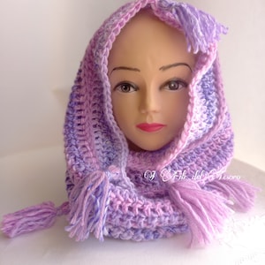 May include: A purple and lavender crocheted cowl with a hood and tassels. The cowl is made with a soft yarn and has a delicate, feminine look.