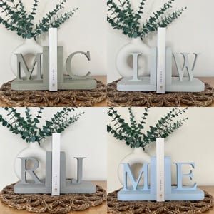 A collage of 4 initial bookends in different colours.