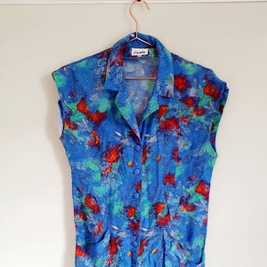 Blue vintage dress, 1980s, sleeveless, knee length, green and red accents. Size 10 approx.