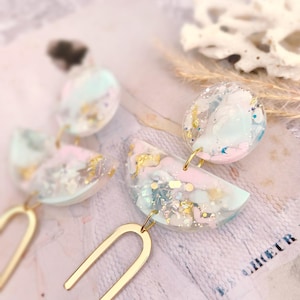 Pink and pastel blue resin earrings, rainbow pattern