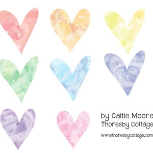 May include: Six watercolor hearts in various pastel colors, including pink, yellow, green, blue, purple, and light pink. The hearts are painted in a loose, abstract style, with visible brushstrokes. The text "by Caitie Moore Thoresby Cottage www.thoresbycottage.com" is at the bottom of the image.