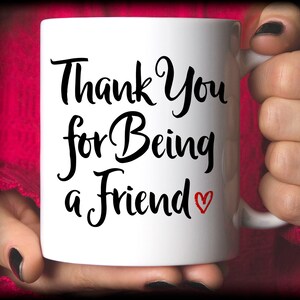 May include: White ceramic mug with black text that reads "Thank You for Being a Friend" with a small red heart.