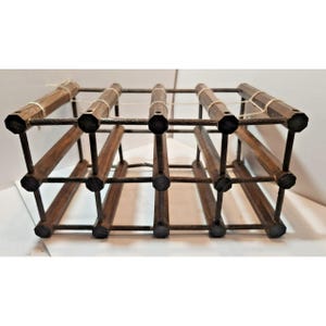 May include: A wooden wine rack with a dark brown finish. The rack is designed to hold multiple bottles, with a grid-like structure. The wooden components are connected by metal rods. The rack is designed to sit on a flat surface.