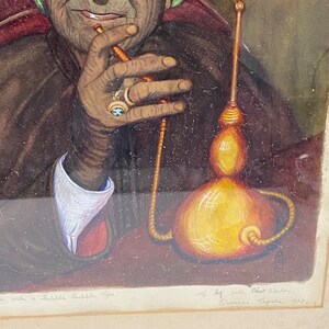 May include: A watercolor painting of a woman wearing a green headscarf, sitting in a chair and smoking a hookah. The painting is signed "To Lily Best Wishes, Queenie Tappe 1923".