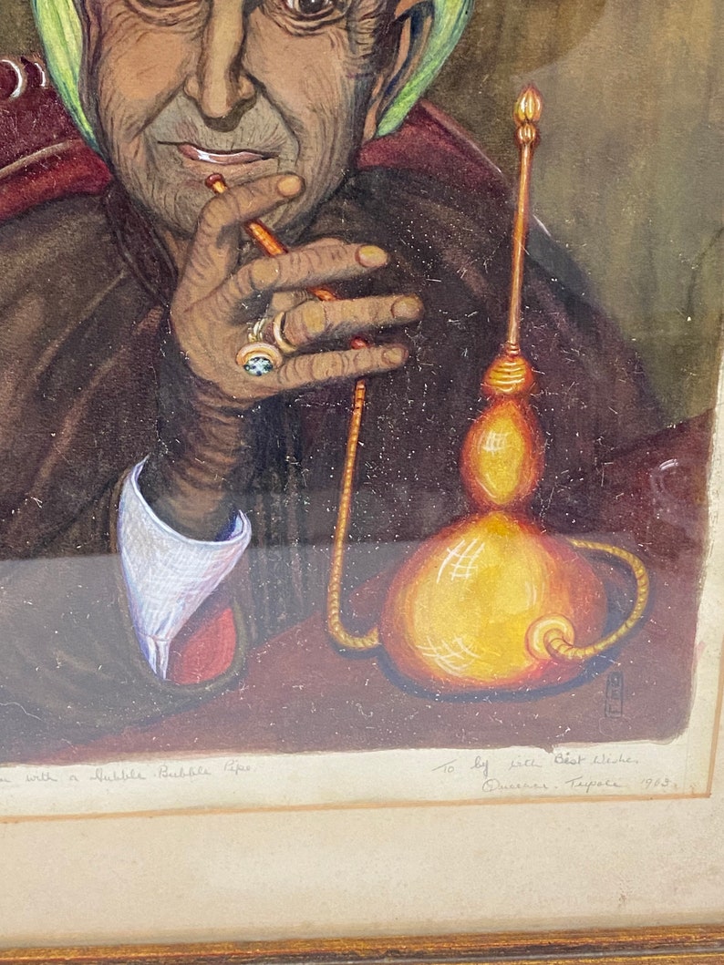 May include: A watercolor painting of a woman wearing a green headscarf, sitting in a chair and smoking a hookah. The painting is signed "To Lily Best Wishes, Queenie Tappe 1923".