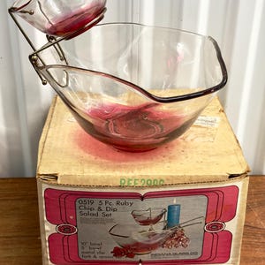 May include: A 5-piece ruby chip and dip salad set in its original box. The set includes a 25.4cm bowl, a 12.7cm bowl, a metal clip, a fork, and a spoon.